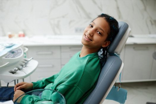 Teen sitting in the patient’s chair at a dental office