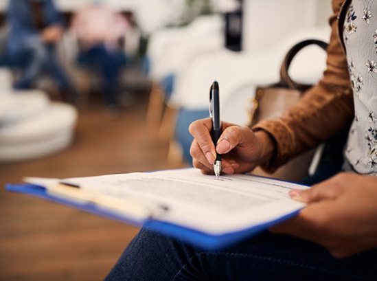 Woman filling out a dental insurance form